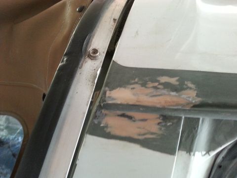 1992 Ford Bronco - Area of car body showing primer and rust, likely undergoing repair.