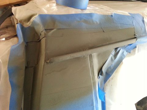 1992 Ford Bronco - A vehicle body panel is covered in blue masking tape, indicating repair work is in progress.