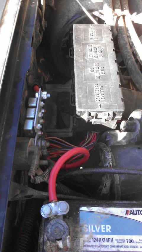 1990 Ford Bronco - Close-up view of the engine bay, showing the fuse box, battery, and various electrical connections.
