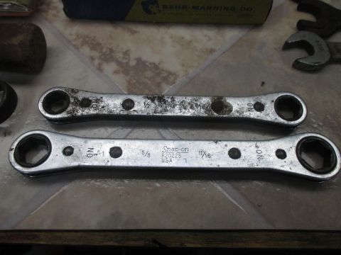 2004 Aston Martin Virage - A pair of Snap-on ratcheting wrenches, one measuring 1/2 inch and the other 11/16 inch, are displayed on a tiled surface.