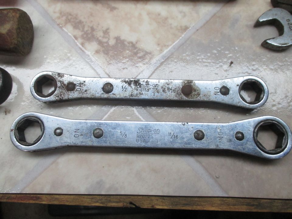 Two Snap-on ratcheting wrenches, one 1/2" x 9/16" and the other 5/8" x 11/16", on a tiled surface
