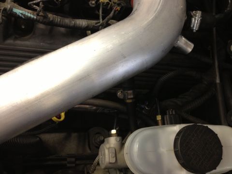 1998 Ford Crown Victoria - Close-up view of engine components and intake piping.