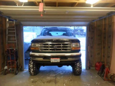 1996 Ford Bronco - Front view of a 1996 Ford Bronco parked inside a garage during winter.