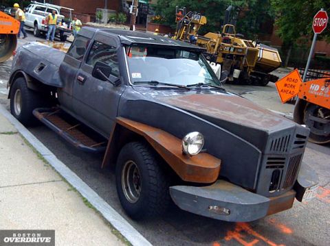 1972 Ford Ranchero - This heavily modified pickup truck features a distinctive front-end design and appears to be on a construction site.