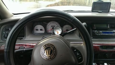 2000 Mercury Grand Marquis - Interior view of a 2000 Mercury Grand Marquis, dashboard gauges and a steering wheel.