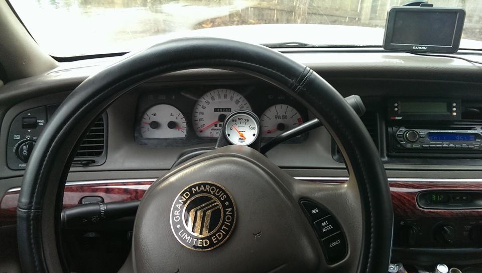 2000 Mercury Grand Marquis interior showing dashboard gauges, steering wheel with 'Grand Marquis Limited Edition' badge, and Garmin GPS