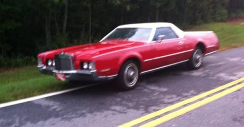 1973 Ford Ranchero - 1973 Lincoln Continental Mark IV coupe with white vinyl roof on a wet road.