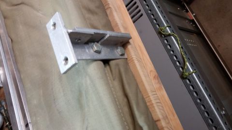 1985 Toyota 4Runner - A metal bracket is attached to a wooden frame, covering tan fabric.