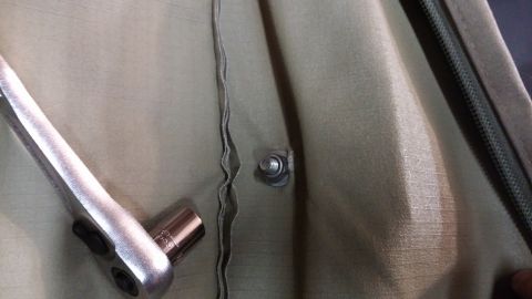 1985 Toyota 4Runner - A socket wrench and socket are positioned on tan awning fabric, near a snap fastener and zipper.