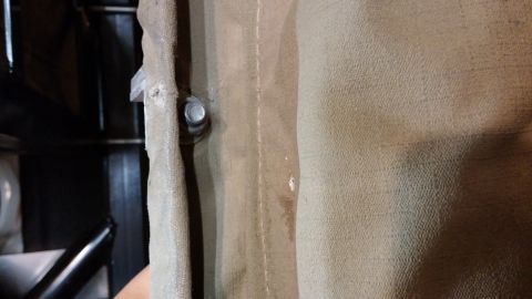 1985 Toyota 4Runner - Detail of awning fabric attachment point, showing a bolt and bracket.