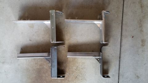 1985 Toyota 4Runner - Two sets of aluminum awning brackets are shown laid out on a concrete surface.