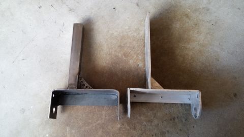 1985 Toyota 4Runner - Two custom-fabricated metal brackets are shown side-by-side on a concrete surface.