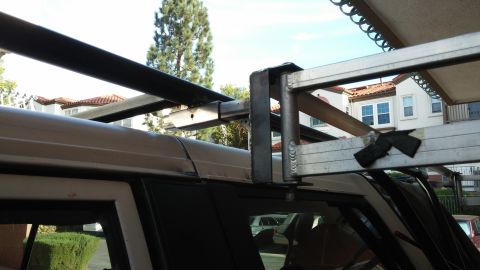 1985 Toyota 4Runner - A custom roof rack system is mounted to the top of a white SUV.