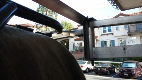 1985 Toyota 4Runner - A metal awning frame is visible in the foreground, obscuring a view of parked cars, including a Toyota 4Runner.