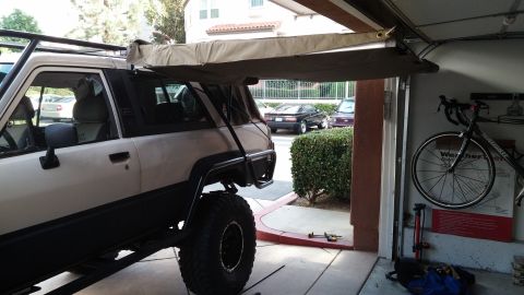 1985 Toyota 4Runner - 1985 Toyota 4Runner equipped with an awning and roof rack, partially inside a garage.