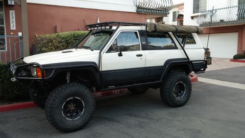 1985 Toyota 4Runner - Modified Toyota 4Runner with off-road modifications and an awning mounted on the roof rack.