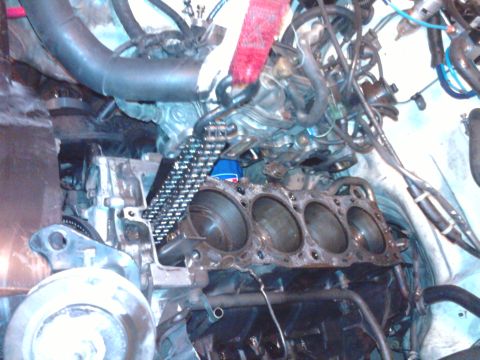 1985 Toyota 4Runner - The engine's cylinder head has been removed, exposing the cylinders and internal components for repair or inspection.