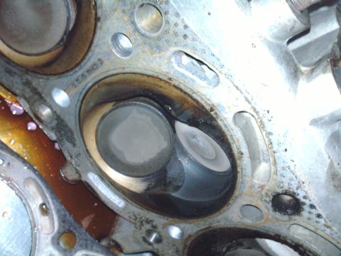 1985 Toyota 4Runner - Engine cylinder head detail with valves and oil residue.