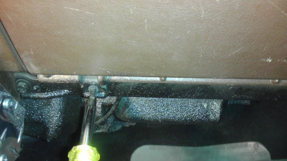 Interior dashboard detail with screwdriver working on a bracket