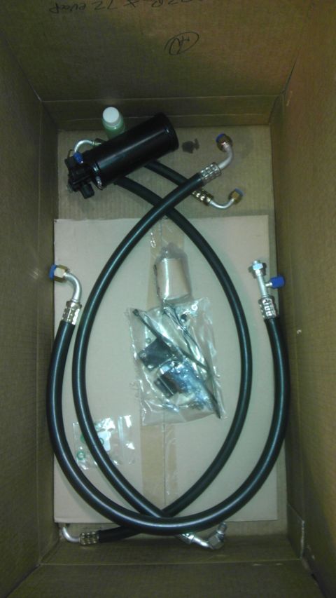 1985 Toyota 4Runner - AC installation parts are laid out in a box, including hoses and a receiver drier.