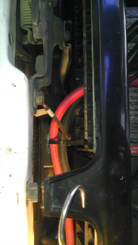 1985 Toyota 4Runner - Close-up view of red hoses and wiring within a vehicle's engine bay.