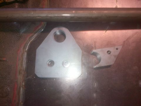 1985 Jeep CJ7 - Close-up of a metal bracket attached to the floor of a vehicle, possibly for modification or repair.