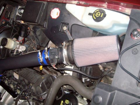 2004 Ford Crown Victoria - Aftermarket air intake system installed on a vehicle's engine.