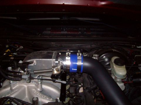 2004 Ford Crown Victoria - Close-up of an engine bay with aftermarket intake components installed.