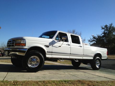 1997 Ford F-350 - This 1997 Ford F-350 crew cab pickup truck is shown from the side under a clear blue sky.
