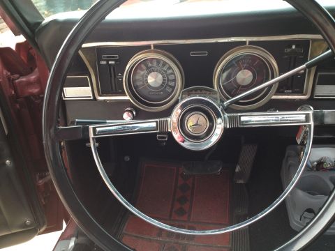 1966 Ford Ranchero - The interior of a classic vehicle, showing the dashboard with its gauges and steering wheel.
