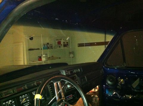 1982 Ford Bronco - The interior of a blue vehicle is shown, with a focus on the dashboard and a speaker mounted in the door.