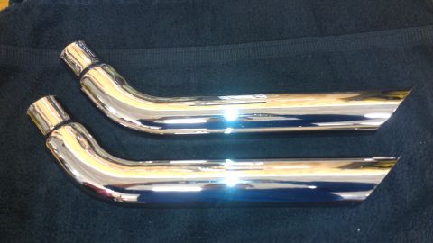 1980 Pontiac Trans Am - Two chrome exhaust pipes are laid out on a dark cloth.