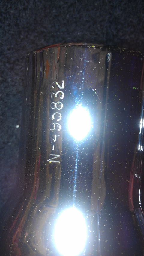 1980 Pontiac Trans Am - A close-up of a chrome part shows a stamped serial number.