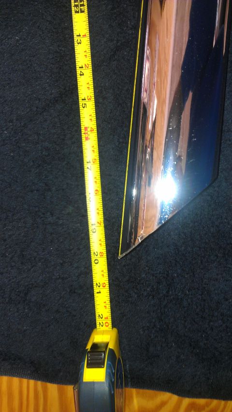 1980 Pontiac Trans Am - A chrome trim piece is measured with a tape measure, indicating its dimensions.