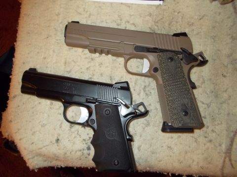 2012 Ford Mustang - Two handguns, a black model and a tan model, are displayed on a cloth surface.