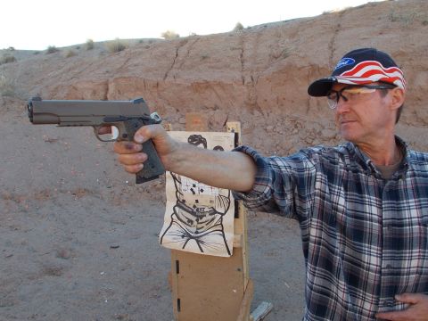 2012 Ford Mustang - Man practices shooting at a target on an outdoor range.