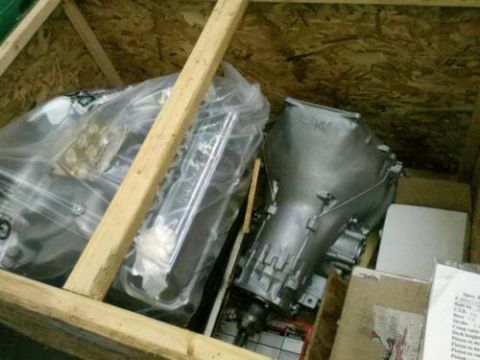 1982 Ford Bronco - Engine and transmission components are packed inside a wooden crate for shipping.
