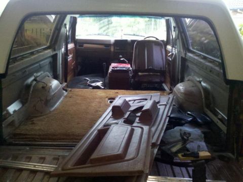 1982 Ford Bronco - Interior view of a 1982 Ford Bronco with parts removed for work.