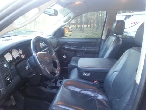 1967 Ford Mustang - The interior of a Dodge Ram pickup truck is shown, with a trailer parked outside.