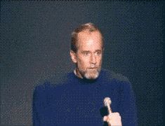 2000 Mercury Grand Marquis - George Carlin, a stand-up comedian, is seen on stage with a microphone.