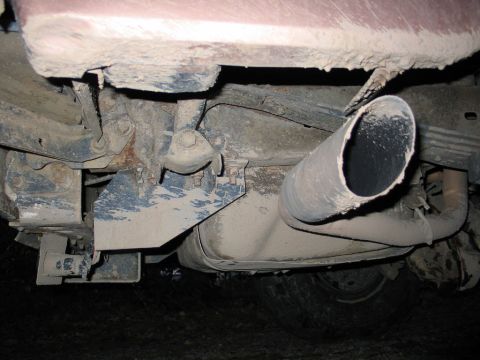 1995 Ford Bronco - Underside view of a vehicle's exhaust system, showing the muffler and tailpipe.