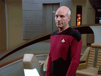 2000 Mercury Grand Marquis - A man in a red uniform stands in a room, possibly on a starship.