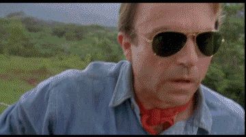 2000 Mercury Grand Marquis - A man in a denim shirt and sunglasses appears worried in an outdoor setting with green hills in the background.