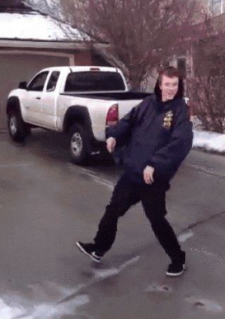 2000 Mercury Grand Marquis - A person stands on a snowy road in front of a white pickup truck.