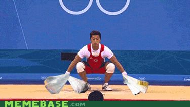 2000 Mercury Grand Marquis - Athlete competes in weightlifting event at the Olympics, focusing on the lift.