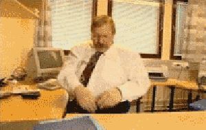 2000 Mercury Grand Marquis - A man sits at his desk in an office environment, appearing to be occupied with something on his lap.