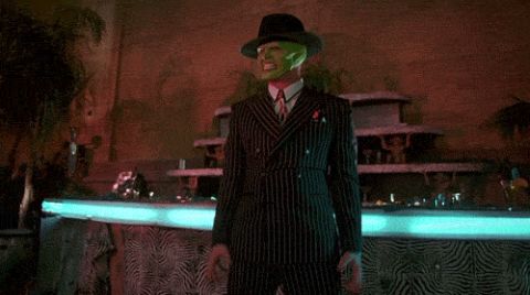 2000 Mercury Grand Marquis - A person in a hat and coat stands before a dimly lit background with colored lights.