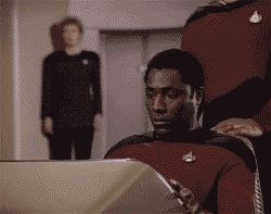 2000 Mercury Grand Marquis - A man in a Starfleet uniform is intently focused on a computer console.