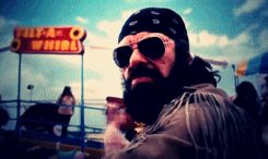 2000 Mercury Grand Marquis - A man with a bandana and sunglasses is seen at an amusement park with a 'Skit-A-Whirl' sign in the background.