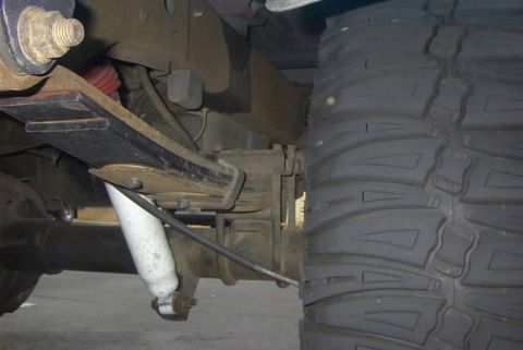 1994 Ford Bronco - The image shows the rear leaf spring, shock absorber, and a large off-road tire.